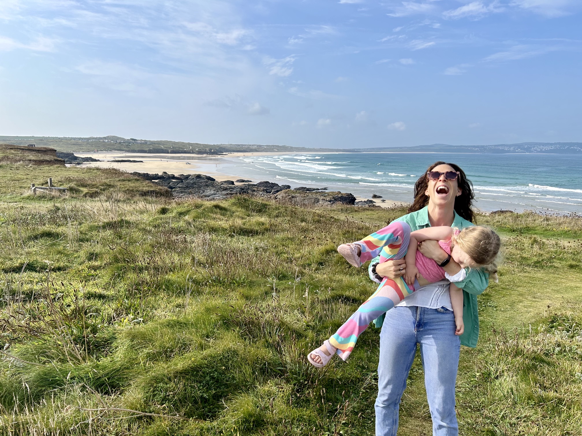 Sam with her daughter by the sea